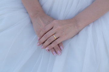 Fototapeta na wymiar Close up and selective focus at golden-diamond ring which is wear on bride's finger. Wedding or married , happiness moment concept photo.