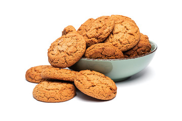 fresh tasty oatmeal cookies in a turquoise plate on a white background