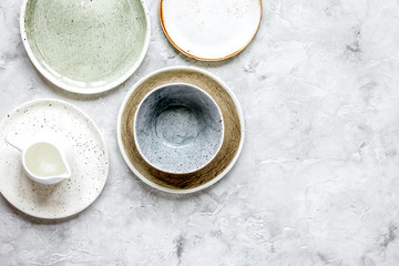 ceramic tableware top view on stone background mock up