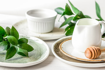ceramic tableware with flowers on white background