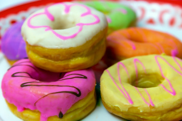 Donuts of various colors combined on the floor