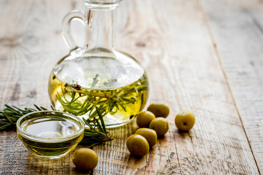 jar with oil with olives on wooden table background mock up