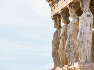 Row of Caryatid statues from Erechtheion temple in Acropolis of Athens with shallow depth of field - obrazy, fototapety, plakaty