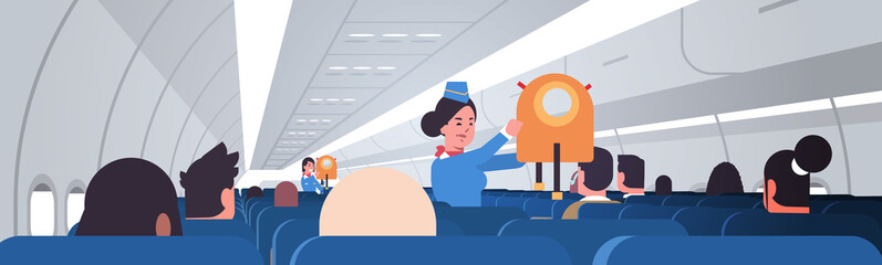 stewardess explaining for passengers how to use jacket life vest in emergency situation female flight attendants safety demonstration concept modern airplane board interior horizontal portrait vector