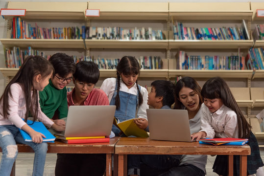 Education image,asian teacher,children,boy and girl happy learning in library at school.
