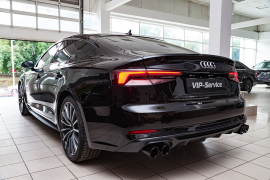 Rear view of the 2019 Audi A5 Sportback  prepared for sale and exhibited in the showroom with a polished shiny black body.