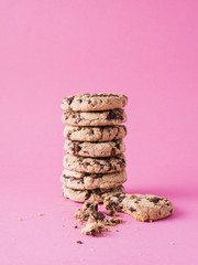 pile of cookies or chocolate chips on pink background