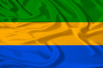 beautiful photo of the national flag of Gabon on delicate shiny silk with soft draperies, the...