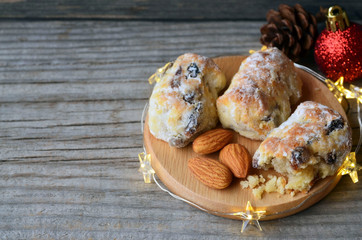 Traditional German,Swiss and Austrian Christmas pastry mini stollen cakes with dried fruit,nuts and spices on a rustic table.Winter festive baking concept.Selective focus.