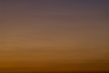 Orange horizon and blue atmosphere. Smooth orange blue gradient of dawn sky.