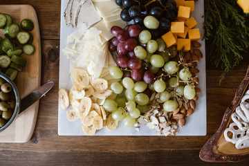 grapes, cheese and nuts on board - 310463619