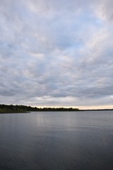 Stormy clouds and sunset over the water