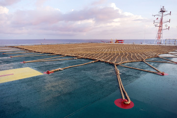 Rope netting on a helideck of a construction work barge at oil field