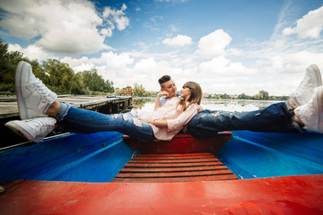 Love is all that matters. Top view of beautiful young couple taking selfie using smart phone while lying in the boat. Love Story.