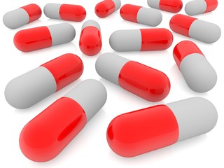 Red medical capsules on white