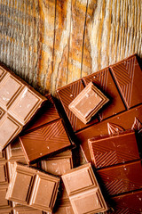 black and milk chocolate bars dark wooden table background top view mockup