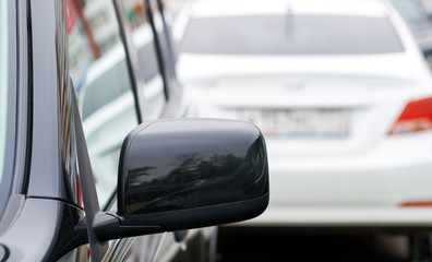 Rearview mirror on the background of the car