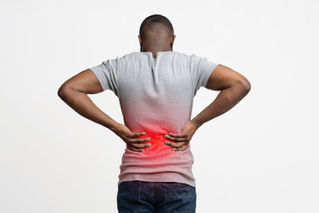 Black man holding his hands behind his back