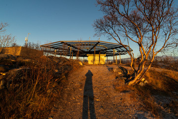 Fototapeta premium Radar on top of the highest spot, Varden, in Tromsø, Norway. There is a long shadow cast by the photographer.
