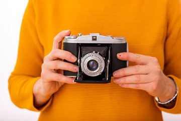 Woman holds nostalgia camera in her hands