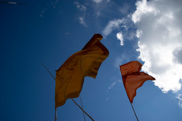 A flag that follows the wind with a background in the sky.