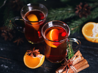 Two glasses of traditional Christmas and winter hot drink mulled wine of red wine with cinnamon, anise, berries and orange