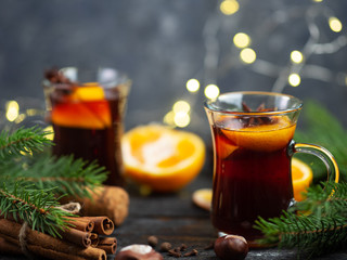 Two glasses of traditional Christmas and winter hot drink mulled wine of red wine with cinnamon, anise, berries and orange