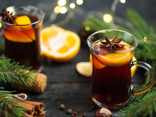 Two glasses of traditional Christmas and winter hot drink mulled wine of red wine with cinnamon, anise, berries and orange