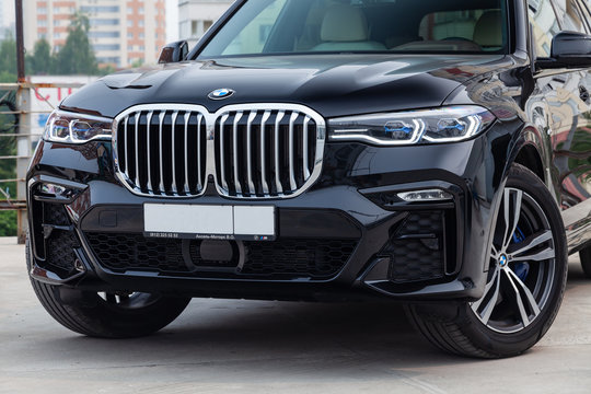 Black new BMW X7 xDrive40i 2019 year front view with light gray interior on parking in the street
