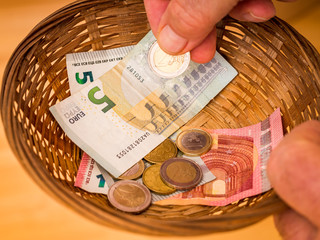 Donate basket with bills and coins