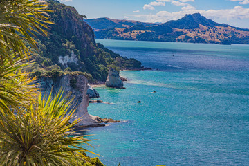 View over cliffy shore of Te Whanganui-A-Hei Marine Reserve on Northern island in New Zealand in...