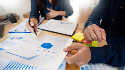 Business People Talking Discussing with coworker planning analyzing financial document data charts and graphs in Meeting and successful teamwork Concept.