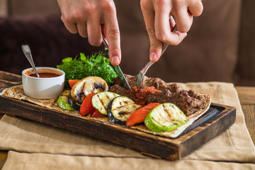 Chicken kebab with grilled vegetables on a wooden plank