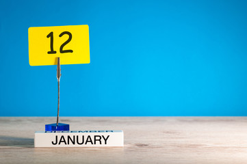 January 12th. Day 12 of january month, calendar on blue background. Winter time. Empty space for...