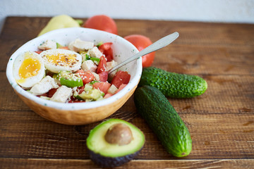 Summer salad with fresh vegetables, avocado and eggs