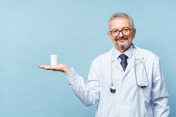 doctor holding bottle of pills on white background. The concept of medicine, pharmacology,...