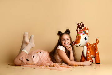 Cute girl with a deer in the studio