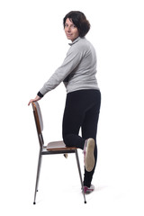 woman standing with a chair in white background