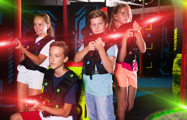 Happy teenagers with laser guns