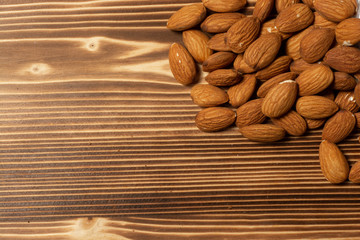 natural almond nuts on wooden background