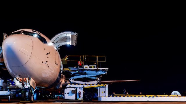 freighter aircraft loading cargo at night