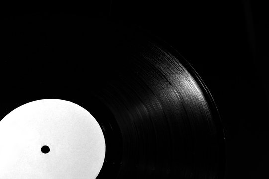 detail of vintage 78 rpm vinyl disk on dark background