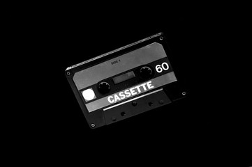 Obraz premium old black audio cassette on dark background