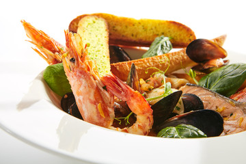 Assorted Seafood with Garlic Baguette on Restaurant Plate Isolated