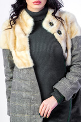 cropped view of woman wearing furry warm coat posing isolated on white studio background
