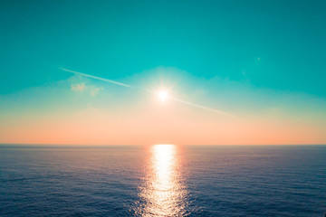 Sun is setting and reflected in an open ocean water sea bay for nature background and backdrop. © junce11