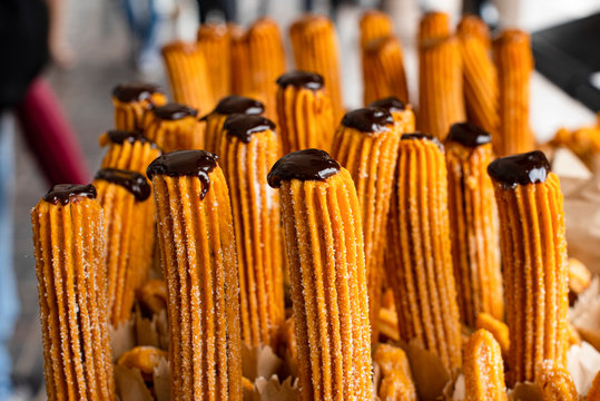 Many churros dipped in chocolate