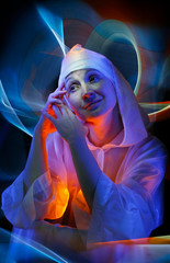 Artistic portrait of a lady in a white created by colored light