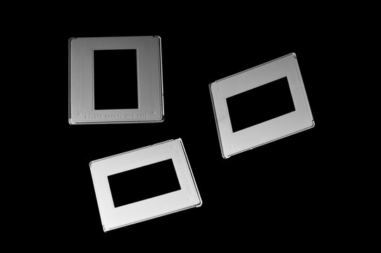 three reversal film frames on dark background
