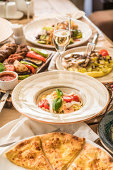 Served table with dishes. side view. light background